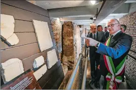  ?? DOMENICO STINELLIS/AP PHOTO ?? Rome’s Mayor Roberto Gualtieri, right, visits the archaeolog­ical findings of the socalled “Sacred Area” on Monday, where four temples, dating back as far as the 3rd century B.C., stand smack in the middle of one of modern Rome’s busiest crossroads.