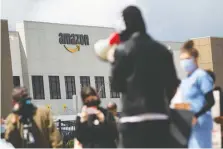  ?? MICHAEL NAGLE/ BLOOMBERG ?? Years of protests against Amazon's work conditions, rights and pay have done little to dent the company's dramatic growth. Above, workers protest in the Staten Island borough of New York.