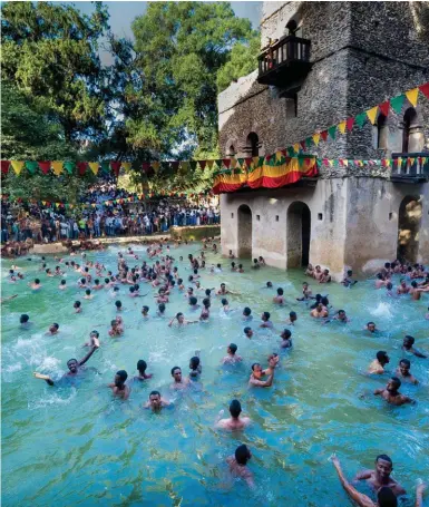  ??  ?? Ritual bathing in Gondar, on the eve of Timkat, to celebrate Jesus’s baptism