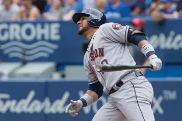  ?? Associated Press ?? Houston Astros' Yuli Gurriel watches the flight of his home run off Toronto Blue Jays starting pitcher J.A. Happ during the second-inning of a baseball game Sunday in Toronto.