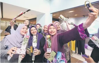  ?? — Bernama photo ?? Female staff members of Pertubuhan Berita Nasional Malaysia (Bernama) gather for a wefie during the Internatio­nal Women’s Day 2024 celebratio­n at Wisma Bernama in Kuala Lumpur.