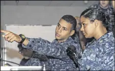  ?? JAMES KIMBER PHOTOS/U.S. NAVY ?? Petty Officer 3rd Class DonPaul Mitchell, left, assigned to the USS Georgia, instructs Ensign Tabitha Strobel, Georgia’s main propulsion assistant, at Naval Submarine Base Kings Bay in Georgia.