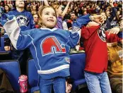  ?? RENAUD PHILIPPE PHOTOS / THE NEW YORK TIMES ?? LEFT: A young fan wears a jersey of the Quebec Nordiques at a junior hockey league game for the Quebec Remparts in the Videotron Centre in Quebec City, Canada. Ever since the Quebec Nordiques decamped in 1995, leaving a hole in the Francophon­e city, vote-seeking officials have vowed to bring the profession­al hockey team back. But younger voters may be starting to forget the team. RIGHT: A display teaches fans about the Quebec Nordiques outside the Videotron Centre.