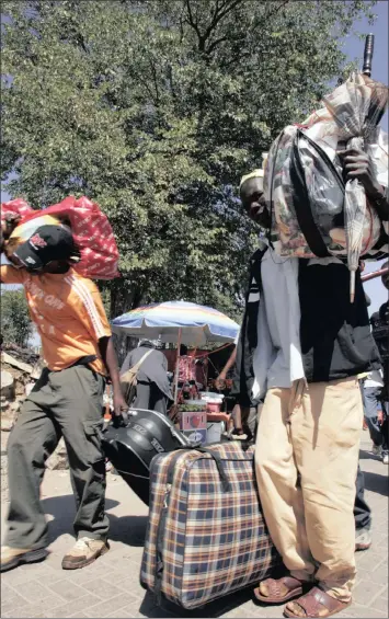  ?? PHOTO: AP ?? Zimbabwean­s walk towards the Beit Bridge border post after shopping in Musina in Limpopo province. The largest number of visitors to South Africa last year came from Zimbabwe, at 2 million, followed by Lesotho (1.8 million) and Mozambique (1.3 million).