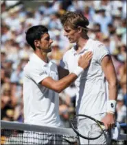  ?? NEIL HALL — THE ASSOCIATED PRESS ?? Novak Djokovic, left, meets Kevin Anderson at the net after defeating him in the men’s singles final match at Wimbledon on July 15.