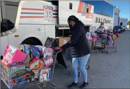  ?? COURTESY PHOTOS ?? First 5San Bernardino employee Renee Jones, in front, and Children’s Fund employee Shari Hunke help unload toys brought in by bus Dec. 17 to a San Bernardino warehouse to contribute to the Children’s Fund’s Celebratio­n of Giving toy drive.
