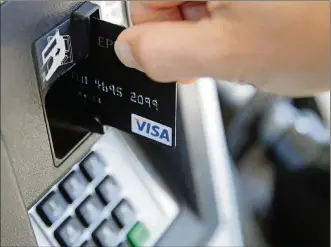  ?? PRESS ELISE AMENDOLA/THE ASSOCIATED ?? In this June 15 file photo, a customer inserts a credit card to buy gas in Haverhill, Mass. It’s always good to pay off your credit card debt, but now may be a better time than ever to do so.