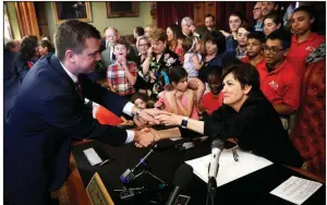  ?? AP/ CHARLIE NEIBERGALL ?? Iowa Gov. Kim Reynolds greets state Senate Majority Leader Jack Whitver after a bill- signing ceremony last year at the Statehouse in Des Moines.