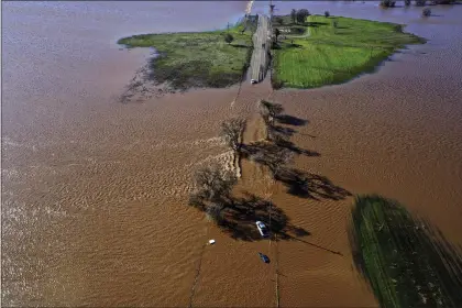  ?? HECTOR AMEZCUA — THE SACRAMENTO BEE VIA AP ?? Three vehicles are submerged on Dillard Road west of Highway 99in south Sacramento County in Wilton Sunday, Jan. 1, 2023, after heavy rains on New Year’s Eve produced levee breaks. Saturday’s system was warmer and wetter, while storms this week will be colder, said Hannah Chandler-Cooley, a meteorolog­ist at the National Weather Service in Sacramento. The Sacramento region could receive a total of 4 to 5 inches (10 to 13 centimeter­s) of rain over the week, Chandler-Cooley said.