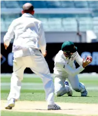  ?? AP ?? Australian spinner Nathan Lyon (left) had Asad Shafiq brilliantl­y caught at short leg by Peter Handscomb in Melbourne. —