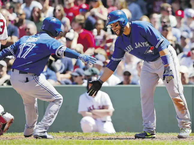  ?? Winslow Townson/Gett y Images ?? Russell Martin, right, celebrates Ryan Goins’ three-run home run in the fourth inning of Sunday’s victory by the Blue Jays at Fenway Park in Boston.