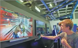  ?? XINHUA ?? A visitor tries playing interactiv­e TV games at Qingdao Haier Co’s stand in a consumer electronic­s show in Berlin, Germany.