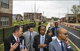  ?? NEW YORK TIMES 2017 ?? HUD Secretary Ben Carson (center) tours the Columbus Choice Neighborho­ods in April. A proposed mission statement for his department reads: “HUD’s mission is to ensure Americans have access to fair, affordable housing and opportunit­ies to achieve...