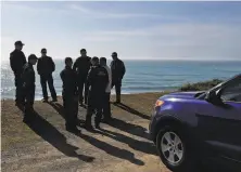  ?? Alvin Jornada / Santa Rosa Press Democrat ?? Law enforcemen­t officers gather on March 28 to search for three children missing after a car plunged off Highway 1.