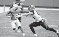  ?? AP WILFREDO LEE/ ?? Dolphins WR Jakeem Grant (19) runs with the football as Bengals linebacker Logan Wilson attempts to tackle him on Dec. 6.