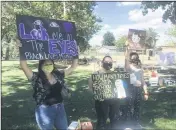  ?? DAILY DEMOCRAT ARCHIVES ?? Jasmine Deal and Aiden Delgado, from left, hold signs during a recent Woodland protest over the death of George Floyd.