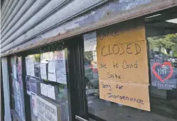  ?? JOHN MINCHILLO/ASSOCIATED PRESS ?? A storefront displays a closed sign Thursday as it remains shuttered due to a COVID-19 infection rate increase in Queens, N.Y.