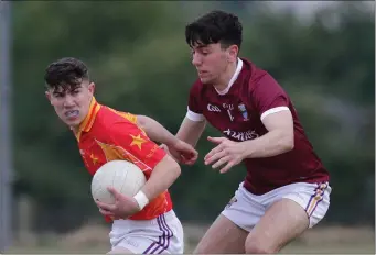  ??  ?? Conor Coleman (St. Martin’s) putting pressure on John Murphy (Starlights).