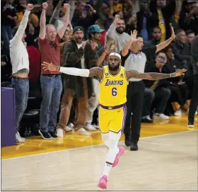  ?? MARK J. TERRILL — THE ASSOCIATED PRESS ?? Los Angeles Lakers forward LeBron James celebrates after hitting a fadeaway jump shot to pass Kareem Abdul-Jabbar and become the NBA’s all-time leading scorer during the second half against the Oklahoma City Thunder on Tuesday night.