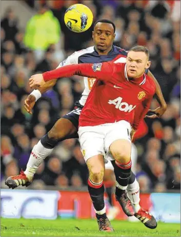  ??  ?? Manchester United’s Wayne Rooney vies with Bolton Wanderers’ Nigel Reo-coker during the Premier League clash at Old Trafford. Rooney missed a first-half penalty and was a relieved man when United went on to win the game 3-0.