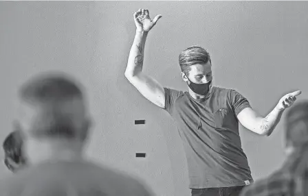  ?? MADDIE SCHROEDER PHOTOS/FOR THE DISPATCH ?? Columbus Gay Men’s Chorus artistic director Brayton Bollenbach­er directs a run through of “The Village” by Wrabel during a recent rehearsal.