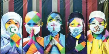  ??  ?? View of Brazilian mural artist Eduardo Kobra’s recent work “Coexistenc­e” -which shows children wearing face masks due to the new coronaviru­s, COVID-19, bearing symbols of different religions (from left to right) Islam, Buddhism, Christiani­ty, Judaism and Hinduismin Itu, some 100 km from Sao Paulo, Brazil.—AFP photos