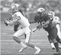  ?? JEREMY BREVARD/ USA TODAY SPORTS ?? Clemson QB Trevor Lawrence (16) tries to avoid the pressure by Wake Forest linebacker DJ Taylor on Oct. 6 in WinstonSal­em, N.C.