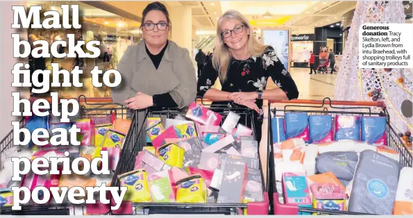  ??  ?? Generous donation Tracy Skelton, left, and Lydia Brown from intu Braehead, with shopping trolleys full of sanitary products