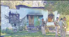  ?? PTI ?? Security personnel near a forest office, in Assam’s West Karbi Anglong, which was vandalised by miscreants on Tuesday.