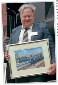  ?? ?? Roy shows off the Ivatt painting at Havenstree­t. PHIL MARSH