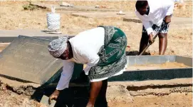  ??  ?? Relatives of the late liberation war hero Micha Dube, his niece Monica Nyathi (right) and sister Khethiwe Dube spruce up Dube’s grave at Nkulumane Heroes Acre yesterday in preparatio­n of today’s Heroes Day celebratio­ns . . . Pic by Dennis Mudzamiri