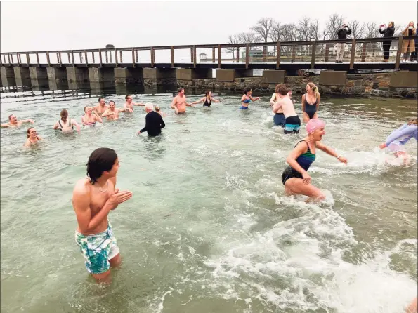  ?? William Jessup / Contribute­d photo ?? Participan­ts in Noroton Yacht Club’s first annual “Polar Plunge” adjust to the frigid temperatur­es of Darien’s harbor on Jan. 1.