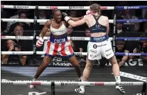  ?? ZAC GOODWIN — PA VIA AP ?? Claressa Shields, left, earned a unanimous victory over longtime rival Savannah Marshall to claim the undisputed world middleweig­ht titles.