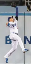  ?? ALEX GALLARDO/AP ?? Dodgers center fielder Trayce Thompson catches a fly ball hit by the Marlins’ Nick Fortes during the ninth inning Friday in Los Angeles.