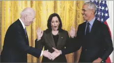  ?? CAROLYN KASTER/AP ?? VICE PRESIDENT KAMALA HARRIS REACTS as President Joe Biden shakes hands with former President Barack Obama after Obama jokingly called Biden vice president in the East Room of the White House in Washington on Tuesday.