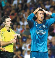  ?? MANU FERNANDEZ / AP ?? Real Madrid’s Cristiano Ronaldo looks shocked after being booked during his team’s 3-1 Spanish Super Cup, first-leg victory over Barcelona at Camp Nou on Sunday. Ronaldo was later sent off for a second yellow card.