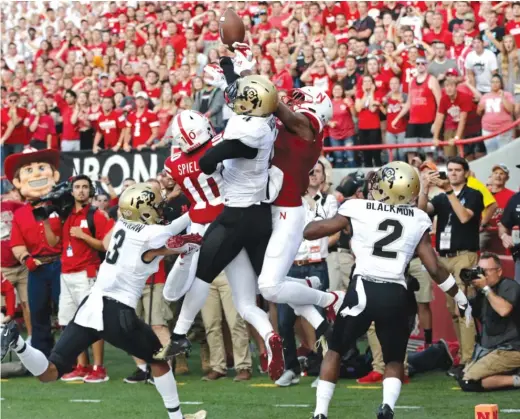  ?? NATI HARNIK/AP ?? Colorado defensive back Dante Wigley (4) breaks up a pass in the end zone intended for Nebraska’s JD Spielman (10) to clinch the Buffaloes’ victory.