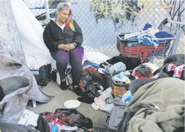  ?? Michael Macor / The Chronicle ?? Shy Brown sits among her belongings at an encampment along Alameda Street in San Francisco. Homeless for seven years, Brown is among the 1,745 of the city’s 6,686 indigent people who are chronicall­y homeless.