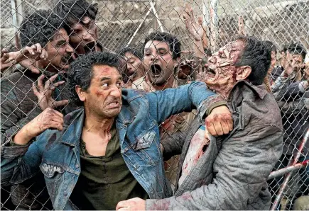  ??  ?? Kiwi actor Cliff Curtis battles zombies in TV show Fear The Walking Dead. Could experiment­s on pig brains give more grunt to the possibilit­y of zombies?