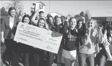  ?? NICK BRANCACCIO ?? Essex District High School teacher Lindsay Drozdz, left, joins students from her Grade 12 leadership program for a parade to the school’s athletic field, where a new grandstand will be built thanks to a $100,000 grant from the Aviva Community Fund.