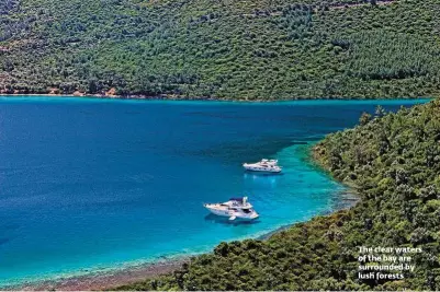  ??  ?? The clear waters of the bay are surrounded by lush forests