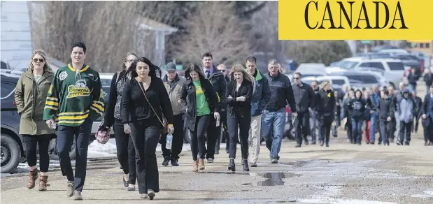  ?? LIAM RICHARDS / THE CANADIAN PRESS ?? Mourners head into a memorial service for Logan Schatz, captain of the Humboldt Broncos hockey team, in Allan, Sask.