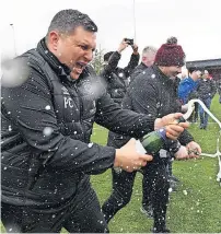  ?? ?? Party time The coaching staff pop open the champagne