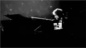  ?? LARRY MORRIS/THE NEW YORK TIMES ?? Bob Dylan performs at Madison Square Garden in New York, January 1974. Dylan, who was awarded the Nobel Prize in literature this year, lived in New York for most of the ’60s and ’70s, where he had a complicate­d romance with the city.