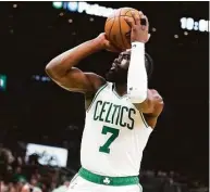  ?? Charles Krupa / Associated Press ?? Boston Celtics guard Jaylen Brown drives to the basket against the Miami Heat during the second half of Game 4 of the NBA Eastern Conference finals Monday in Boston.