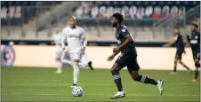  ?? SUBMITTED PHOTO - COURTESY OF PHILADELPH­IA UNION ?? Union defender Mark McKenzie, right, seen in action against New England, became the second Homegrown transferre­d to a European club this year. He’ll play for KRC Genk in Belguim.