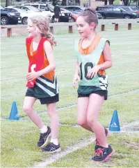  ??  ?? Under nine athletes Darcy Knowles and Elysia Dalton race in the 1100 metre walk. Elysia broke her own record in the race.