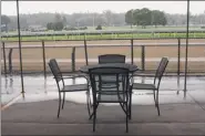  ?? Lori Van Buren / Times Union ?? Rain falls at Saratoga Race Course on Tuesday. Seats at the track will remain empty this season because of COVID-19.