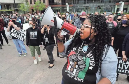  ?? PHOTOS BY FRED SQUILLANTE/COLUMBUS DISPATCH ?? Rally organizer Kiara Yakita leads protesters in a chant before taking to South High Street to march against continued incidents of police killing Black men and women across the country. The protesters marched on Downtown streets and then returned to the Ohio Statehouse where the rally started.