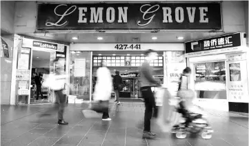  ??  ?? Shoppers walk past the entrance to the Lemon Grove shopping mall in Sydney, Australia; the site of a shopfront company at the heart of one of Australia’s biggest money laundering scandals. — Reuters photo